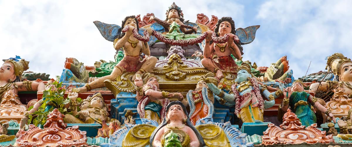A colorful temple with intricate carvings and statues of deities.