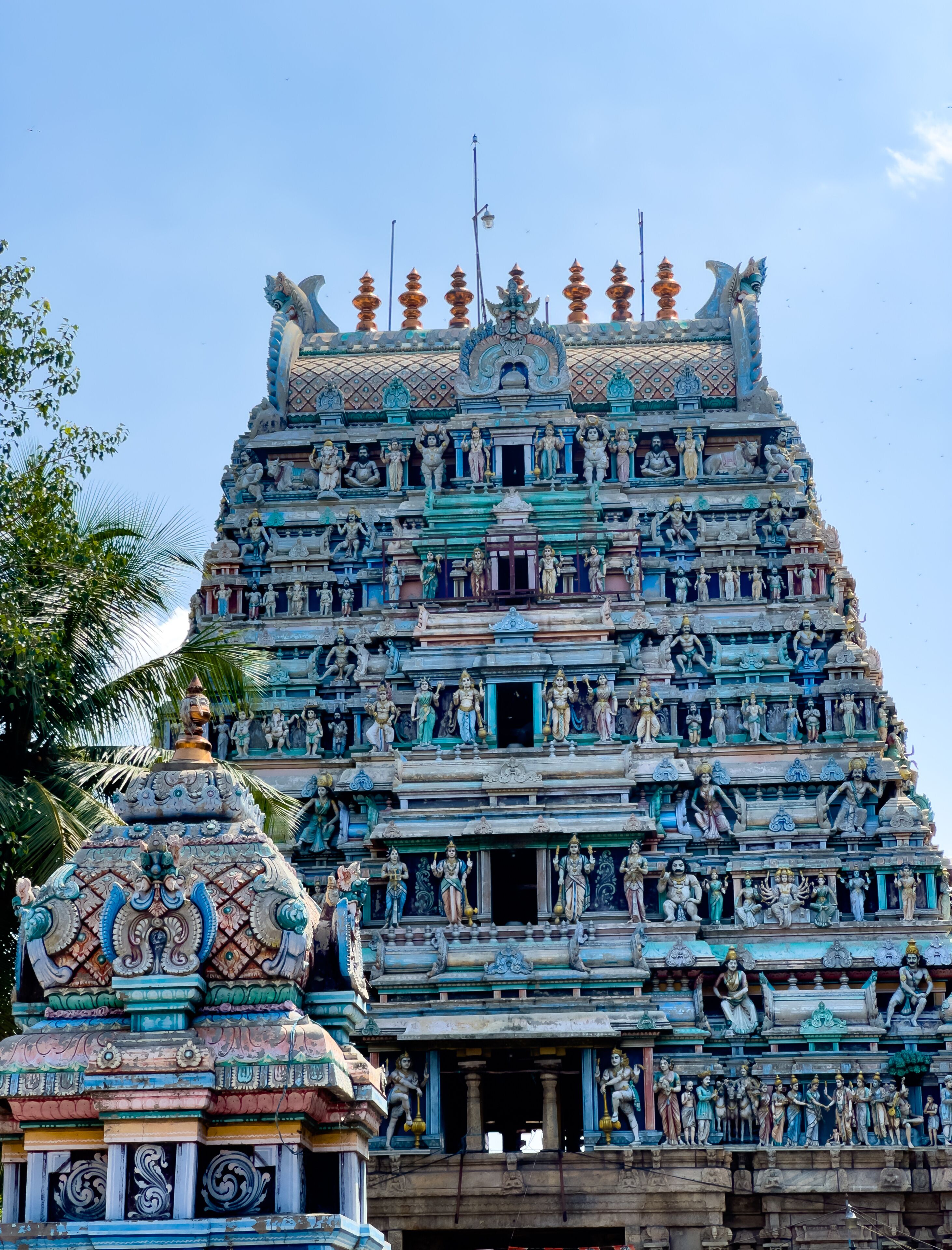 The gopuram tower of Sangameshwarar Temple at Bhavani Kooduthurai in Erode district, Tamil Nadu, adorned with colorful deity sculptures and carvings.