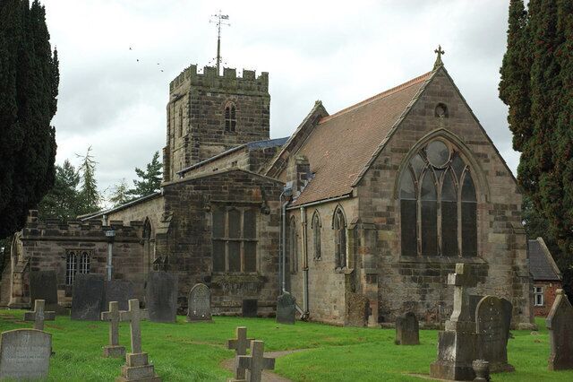 A historic church with a tower and a graveyard.