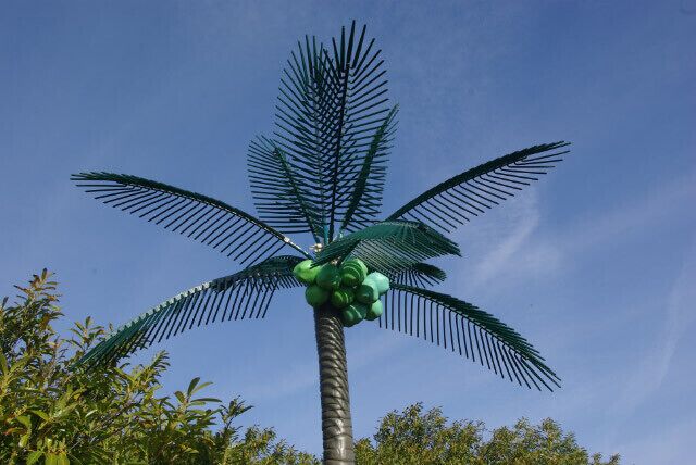 Plastic palm tree. This is one of a pair of plastic palm trees that stand by the entrance to the car park at the former Goji Chinese restaurant - although they may date back to the days when the building was 'Crazy Daisy's' - a night club. Presumably they were intended to give a hint of the orient, or to convince clubbers they were in Ibiza. Either way they are unbelievably tacky, and look distinctly odd standing next to a derelict building - for context see 1236285 .