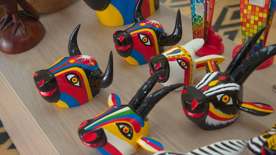 Colorful ceramic animal figurines on a wooden surface.