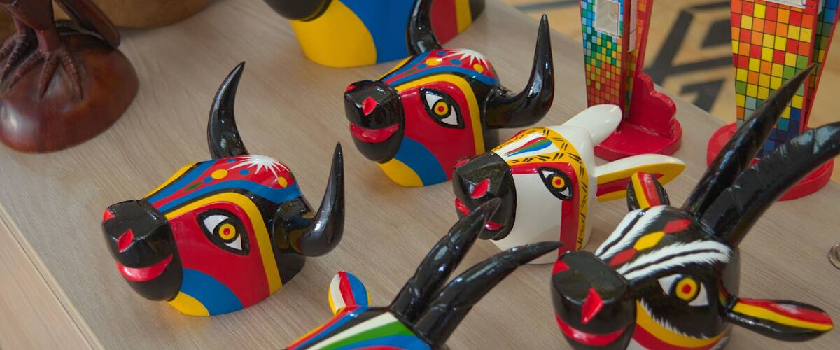 Colorful ceramic animal figurines on a wooden surface.
