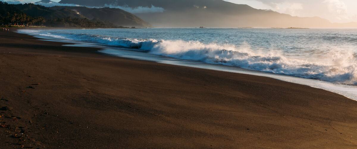 Misty and steaming waves along the shore at dawn in Dingalan, Aurora, Philippines
