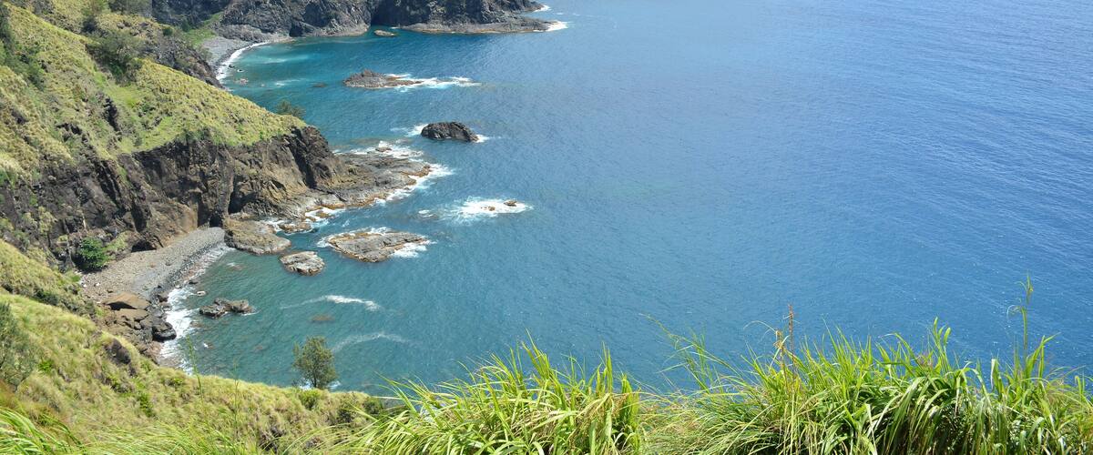 Rock formation and sea water at mountain view white beach resort