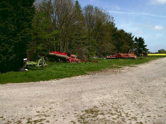 Farm machinery Open air storage for the machinery used to tend fields and sow crops. The wood that can be seen has no name that I know of.