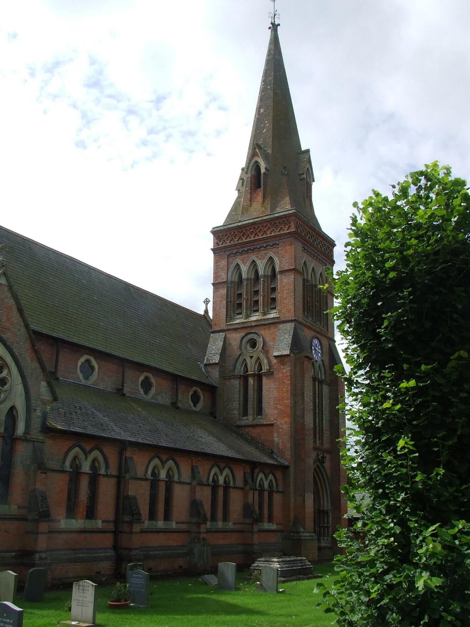 A historic church with a tall spire and arched windows.