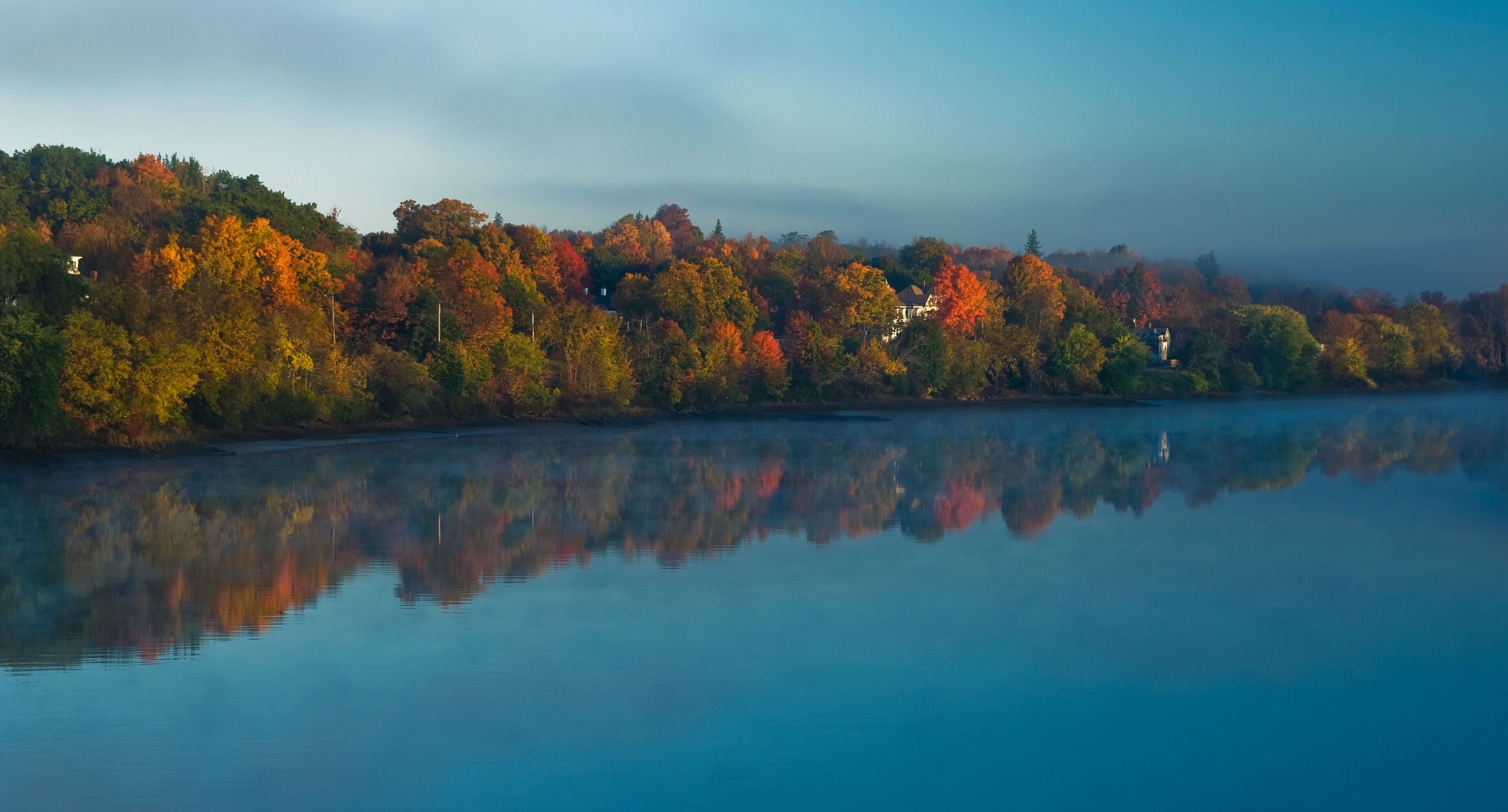 Sunrise breaks through the fog on the kennebec river; Gardiner, maine, united states of america