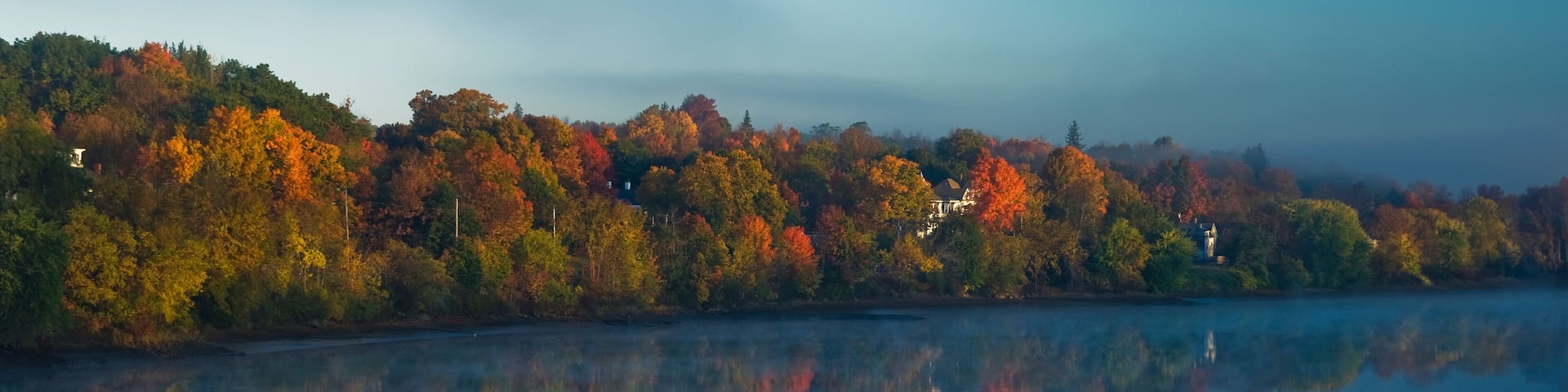 Sunrise breaks through the fog on the kennebec river; Gardiner, maine, united states of america