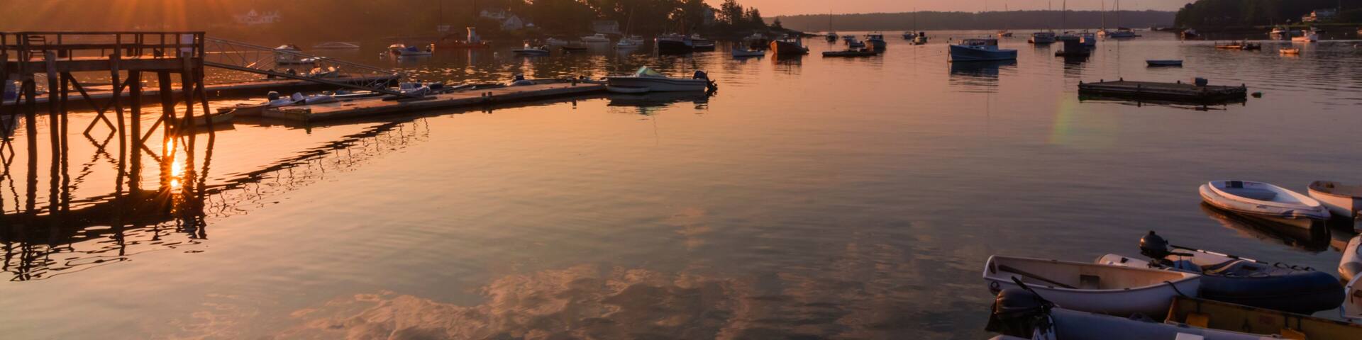 Round Pond Harbor, Maine, USA, boats in the harbor on a quiet still morning at sunrise in summer