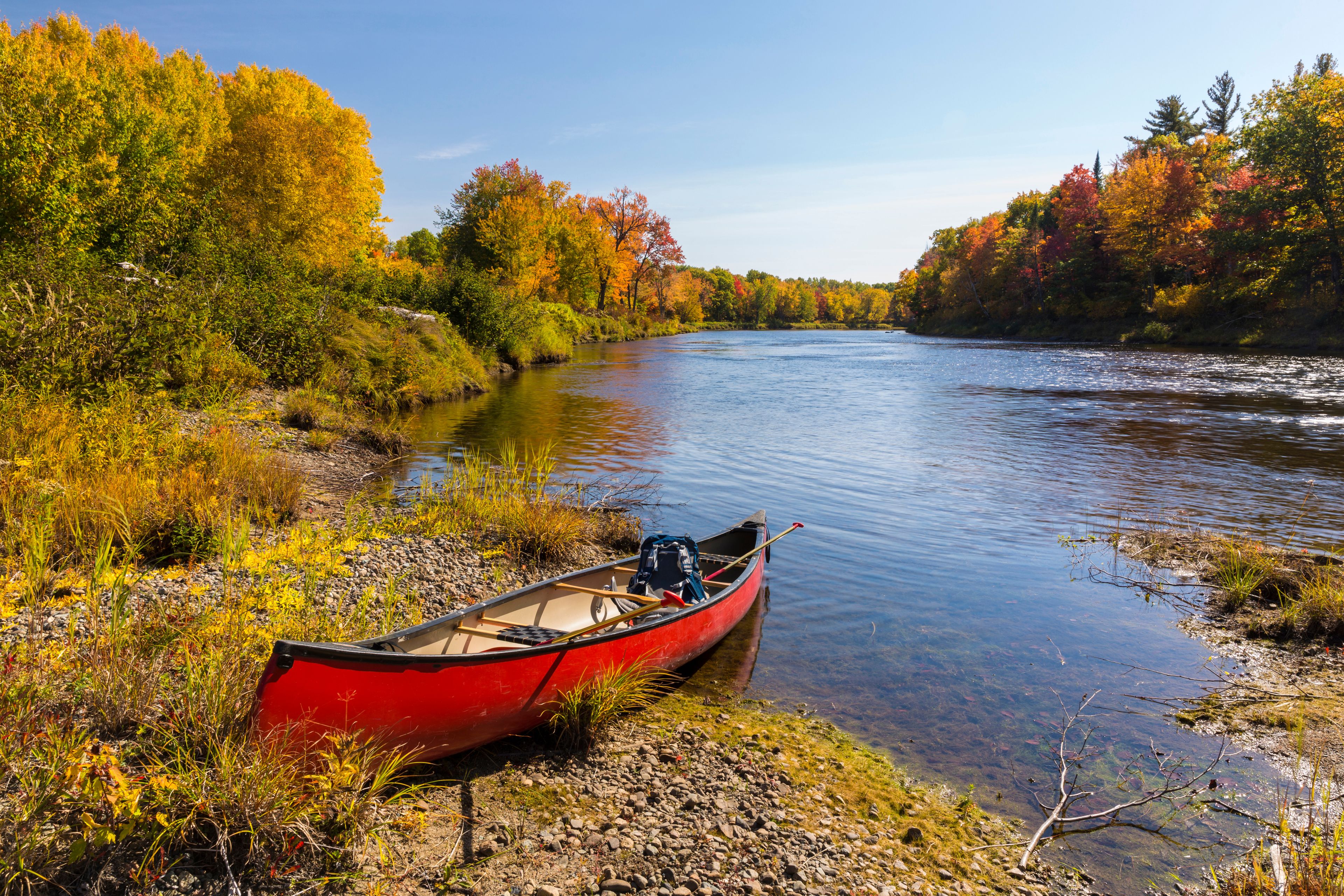 A canoe on the bank of a Maine river. Fall.