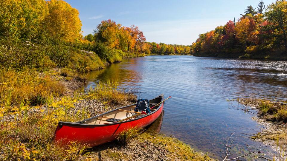 A canoe on the bank of a Maine river. Fall.