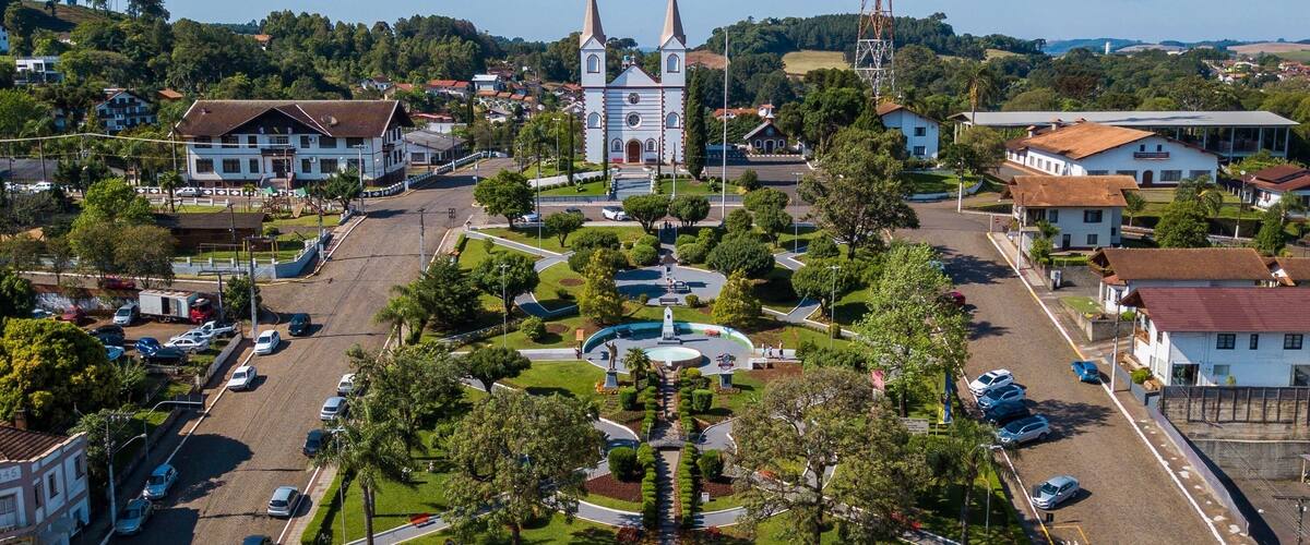 A town square with a church, a fountain, and surrounding buildings.