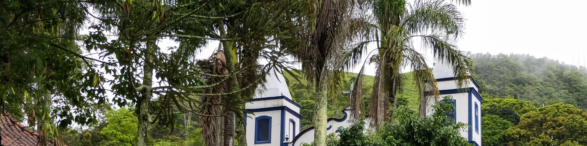 Historical church and park with palms in small town Passa Vinte, Minas Gerais, Brazil
