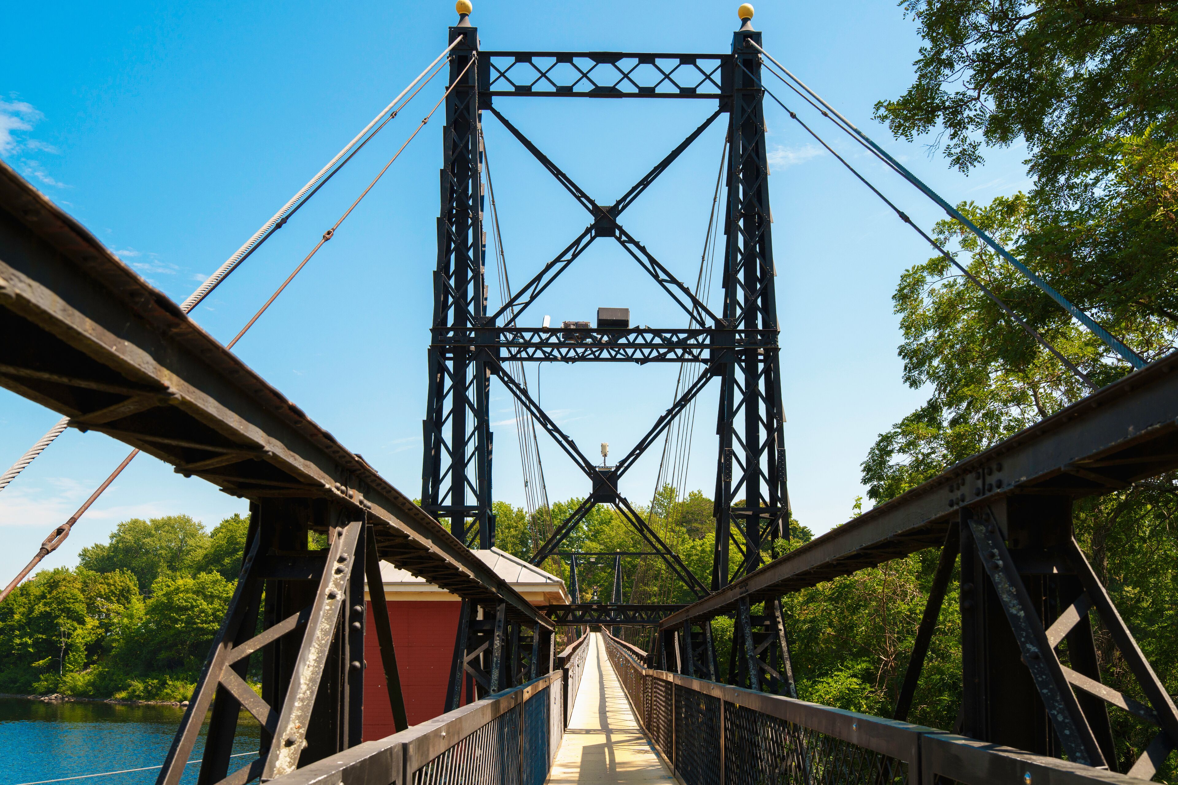 The Ticonic Footbridge, also known as the Two Cent Bridge, a historic 1903 suspension bridge over the Kennebec River, linking Waterville and Winslow in Kennebec County, Maine, USA