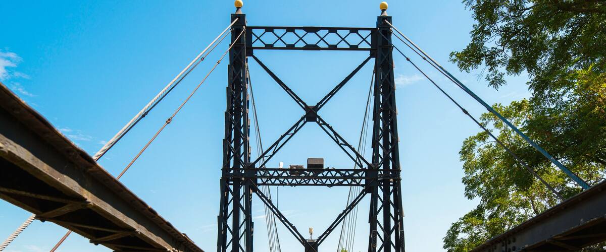 The Ticonic Footbridge, also known as the Two Cent Bridge, a historic 1903 suspension bridge over the Kennebec River, linking Waterville and Winslow in Kennebec County, Maine, USA