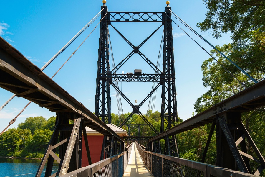 The Ticonic Footbridge, also known as the Two Cent Bridge, a historic 1903 suspension bridge over the Kennebec River, linking Waterville and Winslow in Kennebec County, Maine, USA