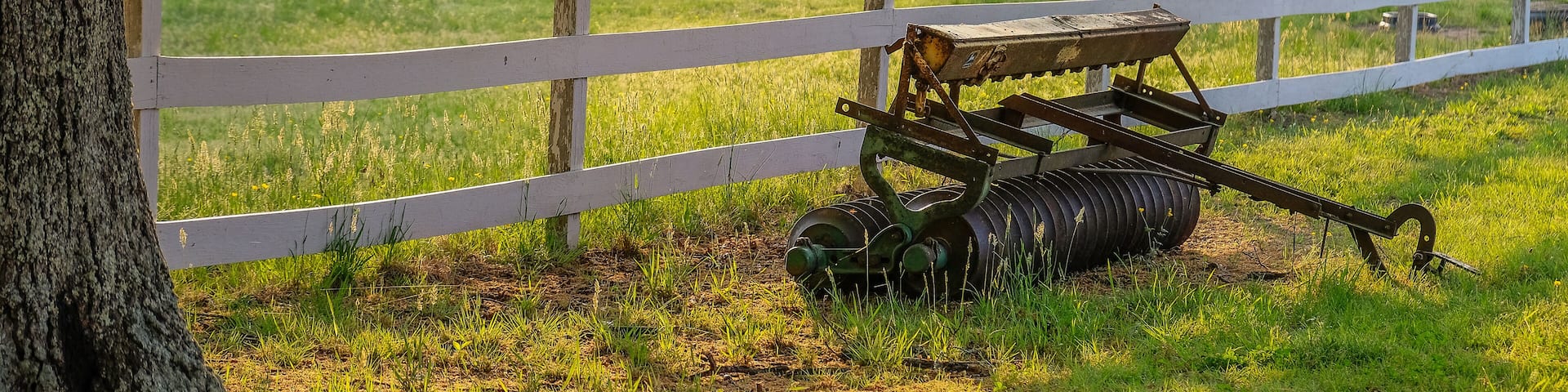 La Plata, Maryland, USA - May 11, 2018: Sunset on the farm with a plow in front of a fence
