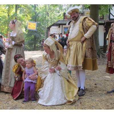 Their Majesties greeting a young visitor.