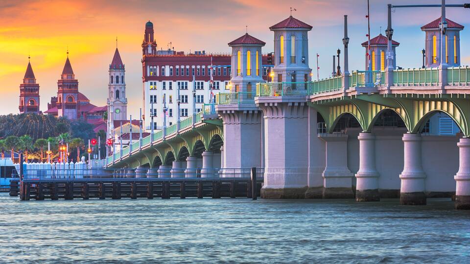 A bridge with towers and a clock tower.
