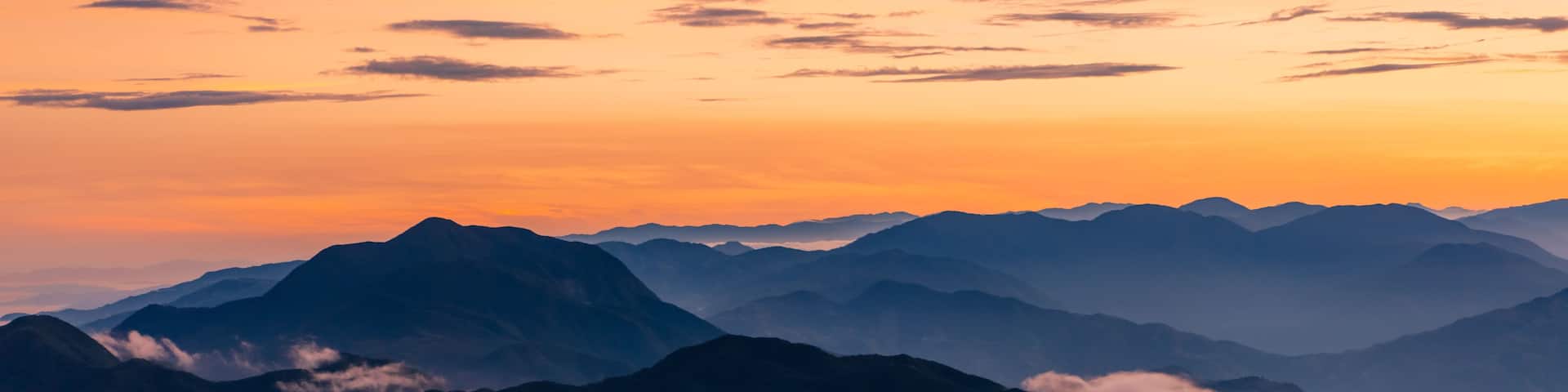 A mountain range with a sunset sky.