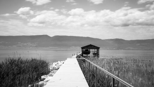 A quite scenic boardwalk leading to a boathouse is spotted along the walk path from Chevroux to Estavayer-le-lac
