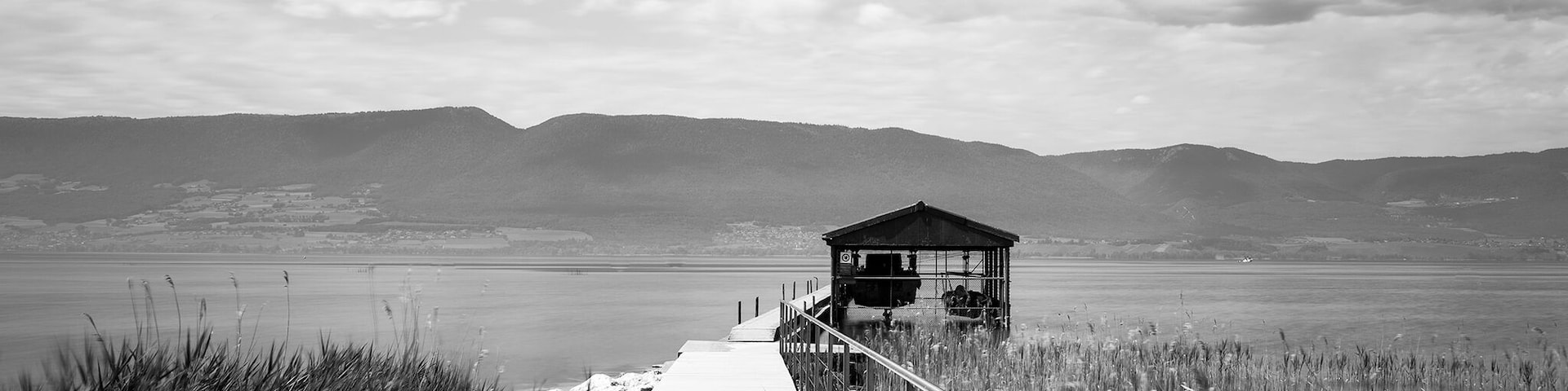 A quite scenic boardwalk leading to a boathouse is spotted along the walk path from Chevroux to Estavayer-le-lac