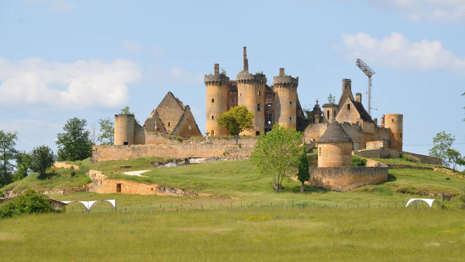 A medieval castle with multiple towers and a moat.