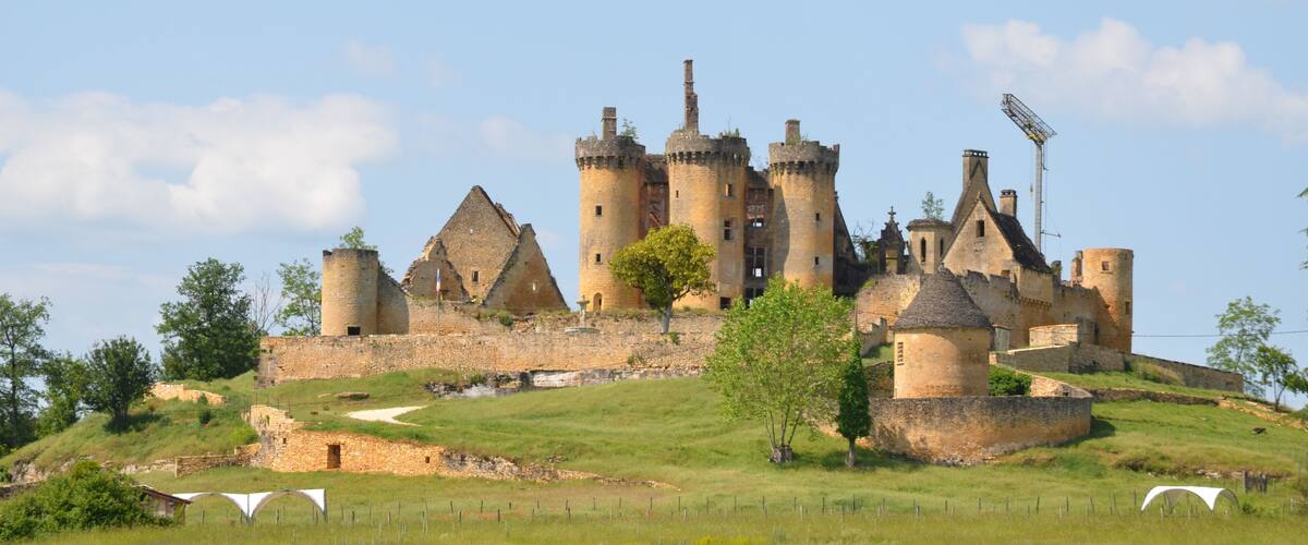 A medieval castle with multiple towers and a moat.