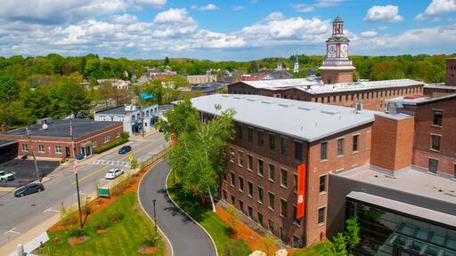 Historic Assabet Woolen Mill, built in 1847, on Main Street on Assabet River in Maynard historic town center in spring, Maynard, Massachusetts, USA.