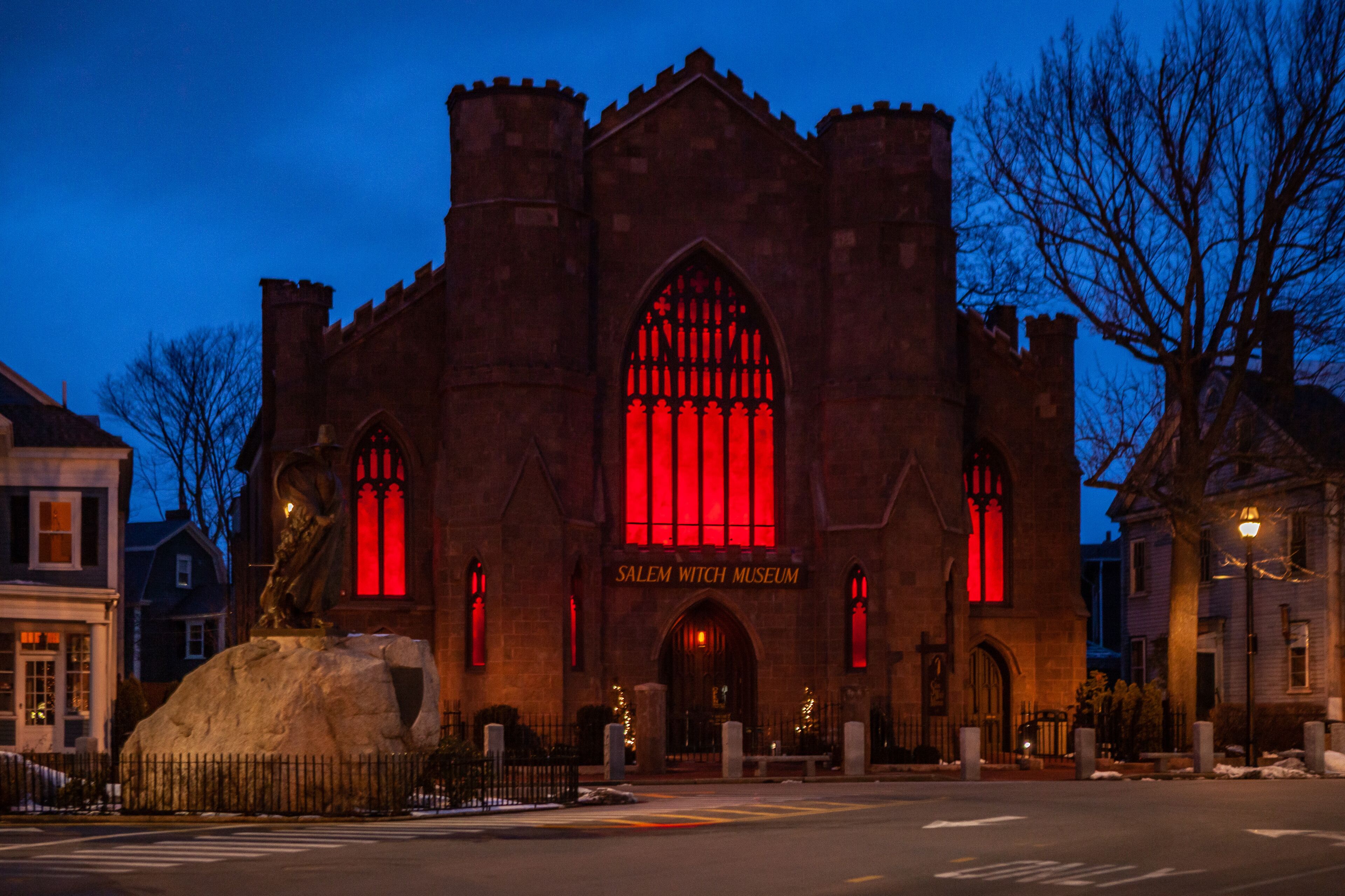 The Salem Witch Museum with a prominent red-lit window and Gothic architecture.