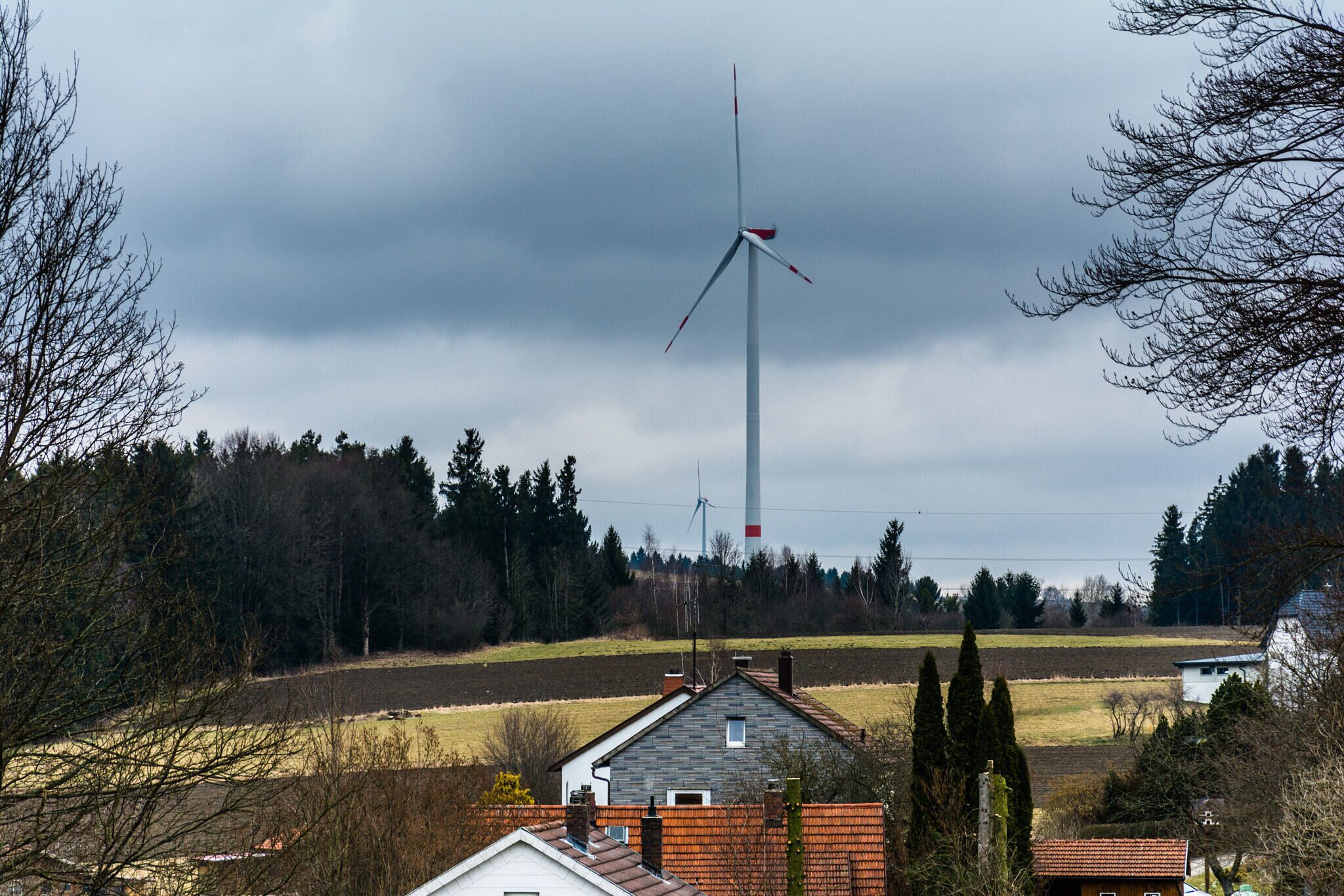 500px provided description: A cloudy day of Spring. [#air ,#field ,#sky ,#forest ,#spring ,#nature ,#buildings ,#clouds ,#cloudscape ,#cloudy ,#house ,#daytime ,#tree ,#branches ,#fence ,#germany ,#windmill ,#cloud ,#day ,#frame ,#framing ,#bavaria ,#depth ,#franconia ,#landscaped ,#nature photograph ,#residential building ,#townscape ,#nature pics ,#free state of bavaria]