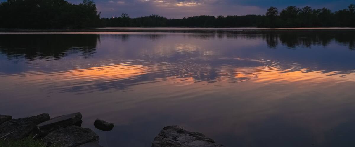 Sunset reflected in the peaceful waters of Ross Lake, Beaverton, Michigan.
