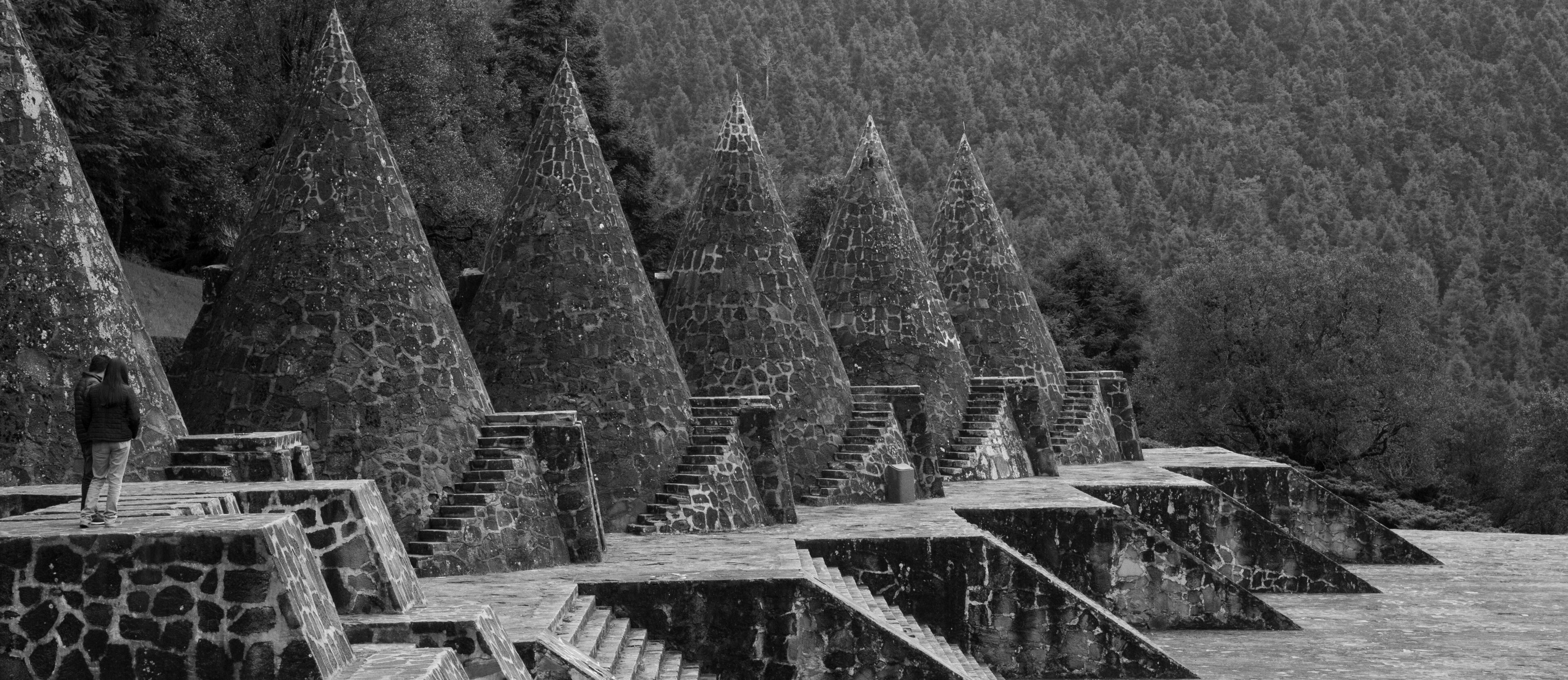 Stone spires and steps in a forested area.