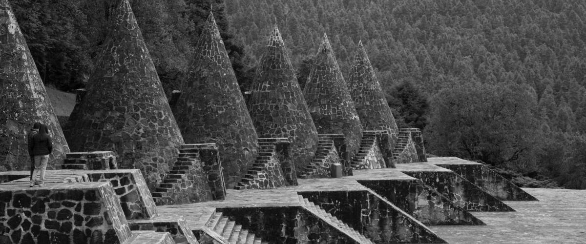 Stone spires and steps in a forested area.