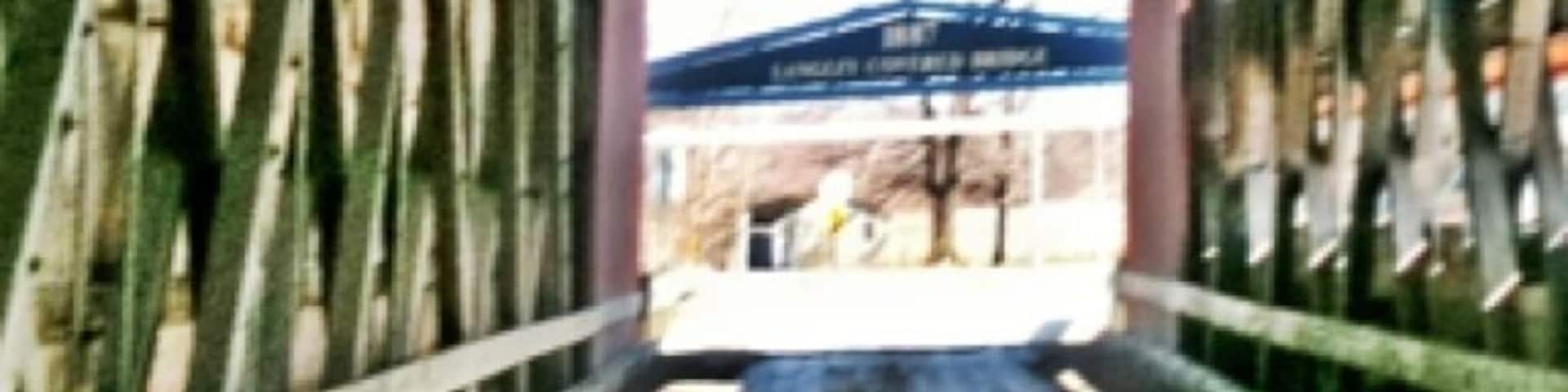 Langley Covered Bridge is the longest remaining wooden covered bridge in the state of Michigan, and is located several miles north of Centreville, Michigan, the seat of St. Joseph County. Many of the covered bridges in Michigan and other states no longer exist, and therefore the structure is an historic landmark and tourist attraction frequented by visitors to St. Joseph County. The bridge is named for Thomas W. Langley and family, pioneers who helped establish the village of Centreville in the mid-19th century. In fact, Langley was the very first settler in Centreville. The red-paneled bridge, along with a causeway just to its north that forms part of Covered Bridge Road, spans the St. Joseph River. The bridge was constructed in 1887 by nearby Parkville builder Pierce Bodmer. It does this just above what is called the Sturgis Dam (although the city of Sturgis, Michigan is located nowhere near this location). The dam is adjacent to a county recreation area called Covered Bridge Park; just across the river within sight of the bridge is Pahl Point Park, which is in fact closer to the bridge itself. The bridge has been a very important symbol for the village of Centreville for almost 100 years; in fact, the village's annual summer festival is called Covered Bridge Days. -wiki
For more info/photos
http://my.net-link.net/~michaelf/langley.htm
#Bridge #CoveredBridge #HistoricSite #Michigan #PureMichigan