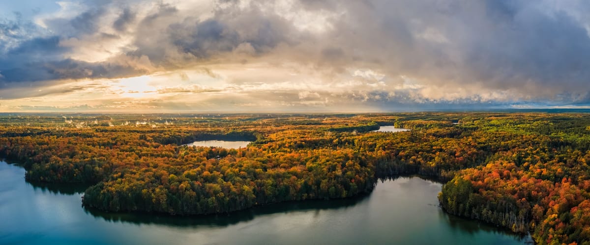 Spectacular autumn sunset over Pete’s Lake Campground 	in the Hiawatha National Forest – Michigan Upper Peninsula – aerial view