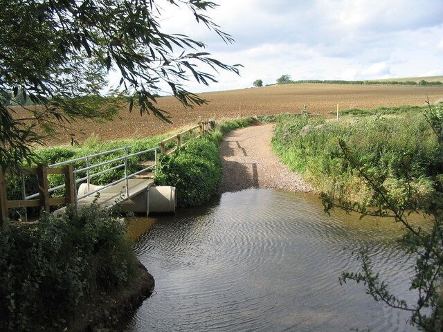 Footbridge and ford, Thorpe Langton. On the track leading to Langton Caudle (using Leicestershire Round) and Stonton Wyville. The popularity of walks along here explains the smart new footbridge.