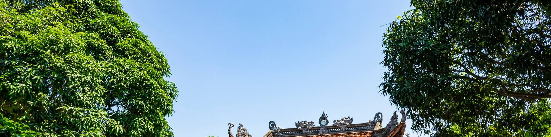 A traditional Chinese temple with ornate architecture, including a curved roof and decorative dragons.