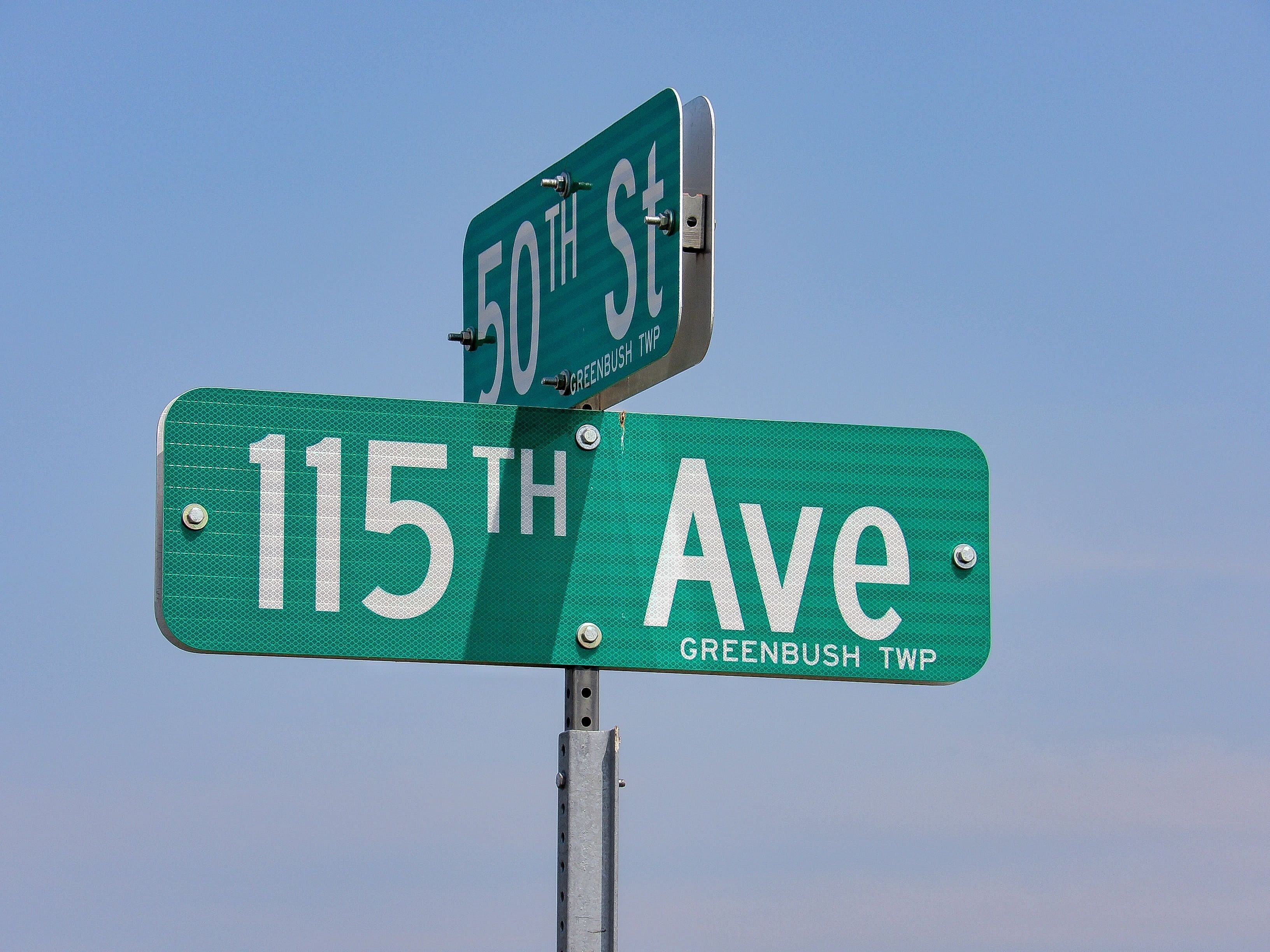 Street signs for 50th St and 115th Ave in Greenbush TWP.