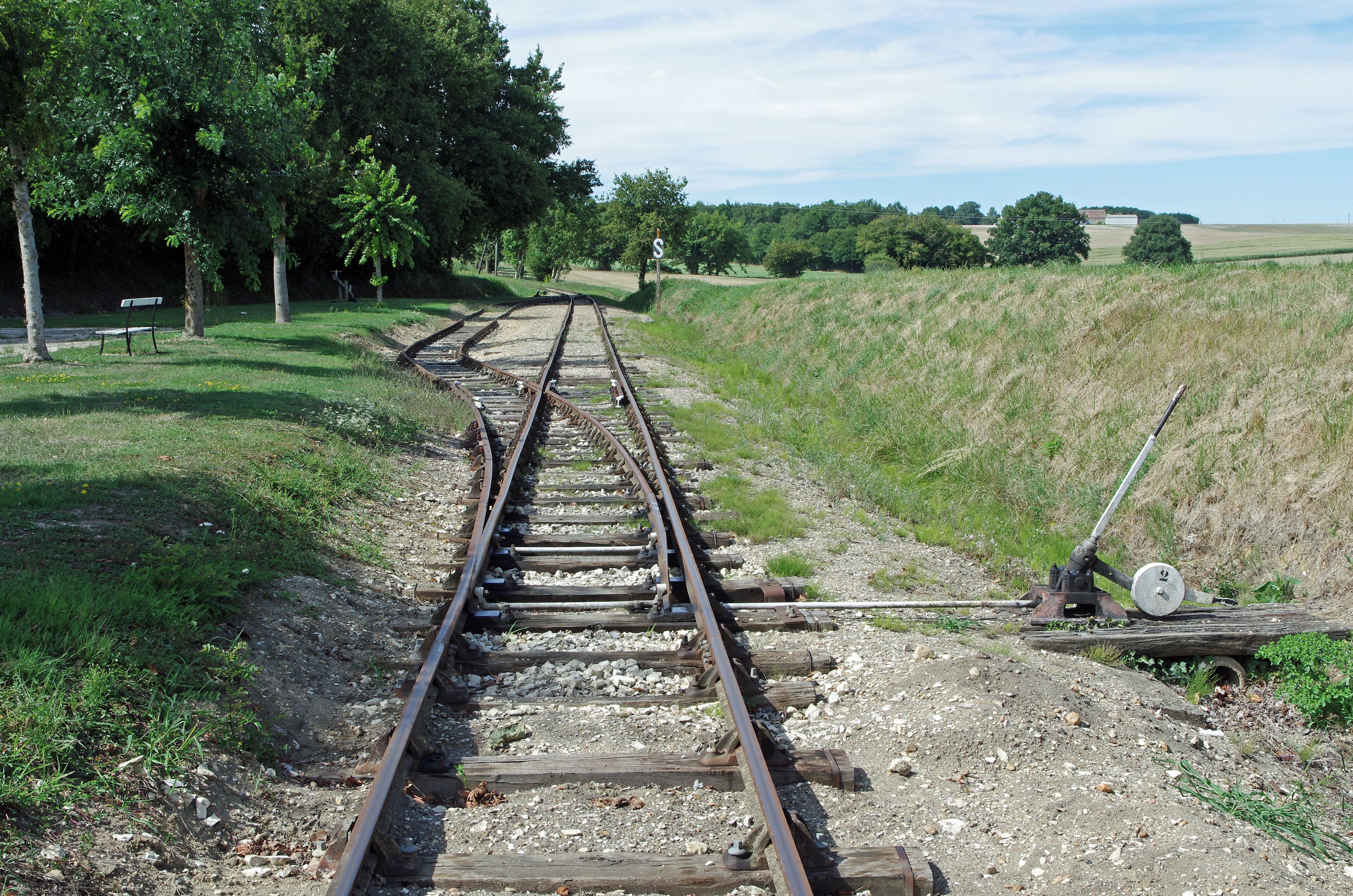 Heugnes (Indre) La gare. L'aiguillage en sortie de gare. La gare d'Heugnes est une gare de la ligne de Salbris au Blanc. Elle est mise en service, le 17 novembre 1902. Le trafic voyageurs a cessé en 1980 et le trafic marchandises en 1988. La ligne a été inscrite au titre des monuments historiques en 1993. Pour la gare, sont conservés : le bâtiment voyageurs avec la halle marchandise accolée, le quai, la lampisterie-toilettes, le puits, le passage à niveau.