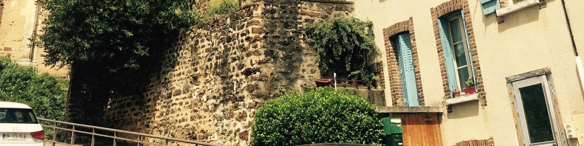 A historic church with a tall spire and stone walls.