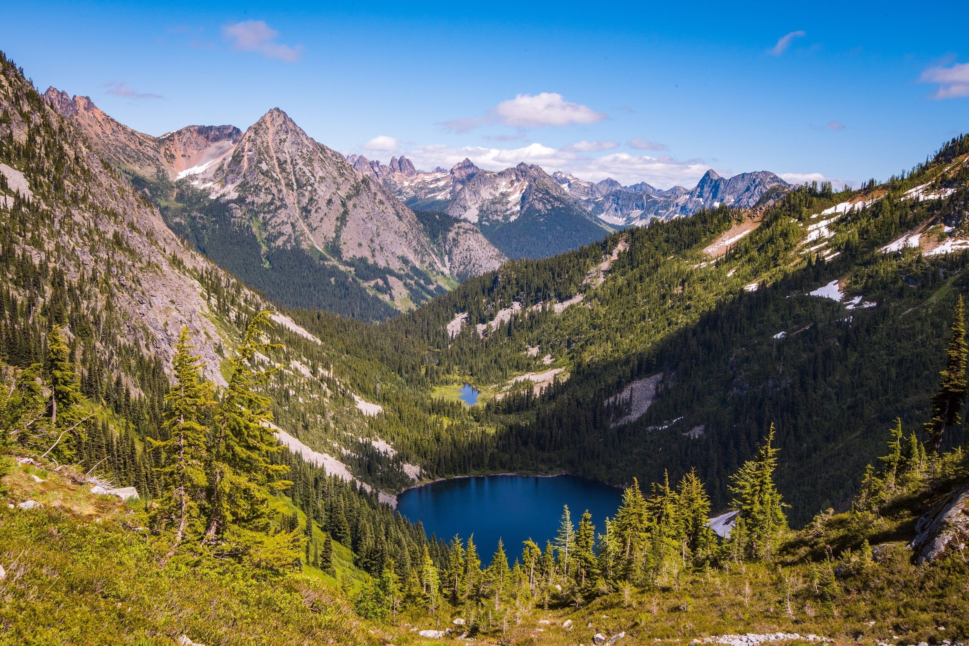 An expansive summer view of the North Cascades and Lake Ann.  Taken from Maple Pass