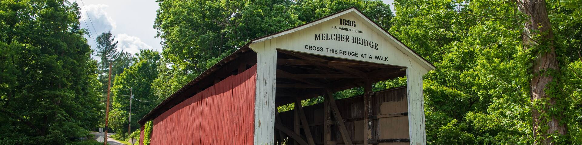 The Melcher Covered Bridge, also known as the Klondyke, Marion, or the Leatherwood Covered Bridge crosses Leatherwood Creek east of Montezuma in Parke County, Indiana