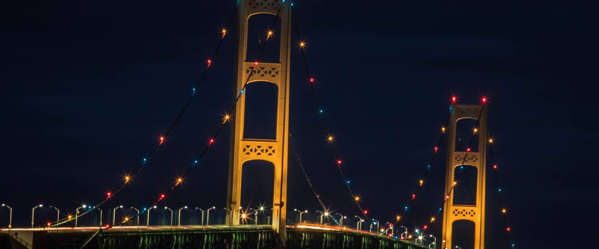 A bridge with two towers and colorful lights.