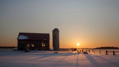 Dilapidated barn at sunrise in winter; Rudyard, Michigan, United States of America