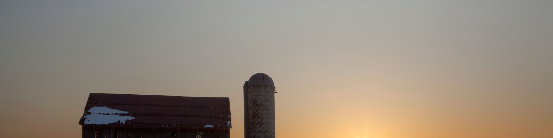 Dilapidated barn at sunrise in winter; Rudyard, Michigan, United States of America