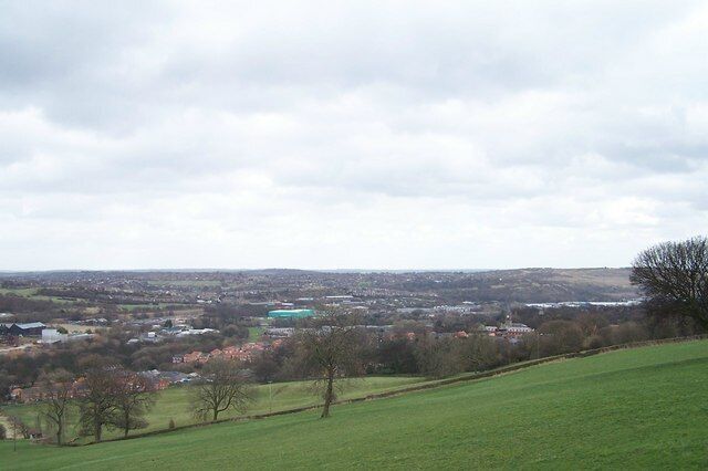 View from Worrall Road towards Sheffield In the centre foreground are houses on the Wadsley Park Village estate, with housing in Winn Gardens immediately behind. The green building is (I think) Fletchers Bakery on Clay Wheels Lane. Just visible on the right hand side, immediately to the left of the tree, are parts of Sheffield Wednesday's Football Ground.