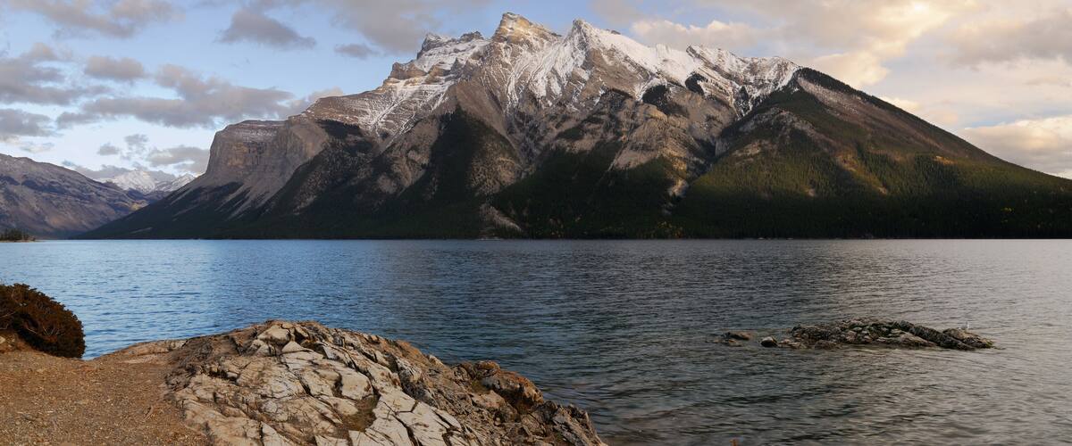 A mountain range with a lake in the foreground.