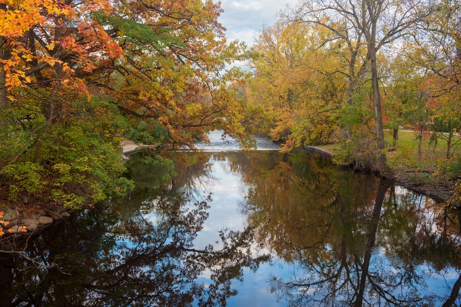 Red Cedar river winding through Michigan State University campus during the Fall