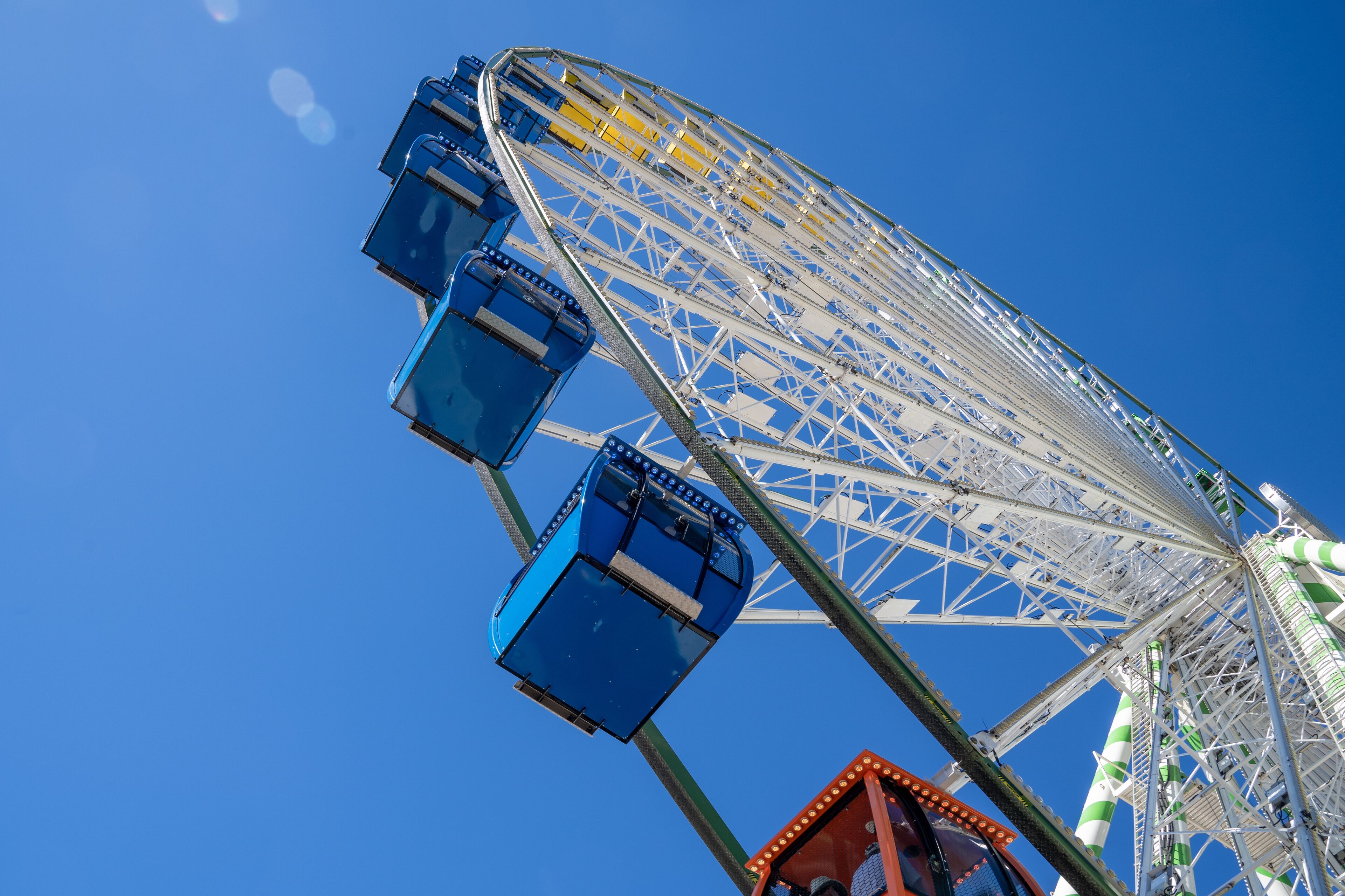 Part of a big colorful vivid ferris wheel on a bright sunny day